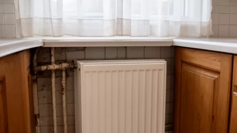 Grzejnik w kuchni za meblami